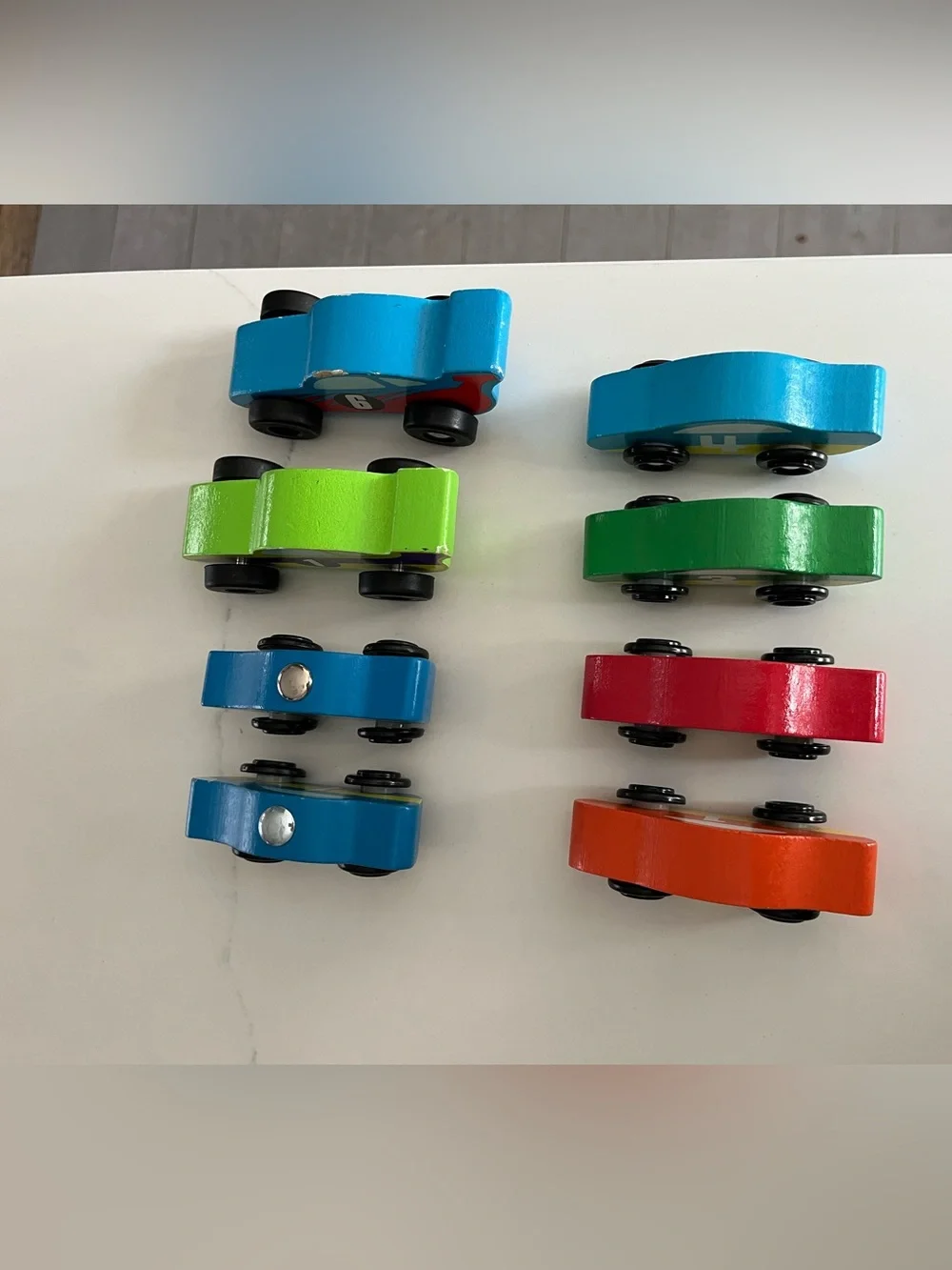8 wooden racing cars.   Cars Number 1-4 are Melissa & Doug.